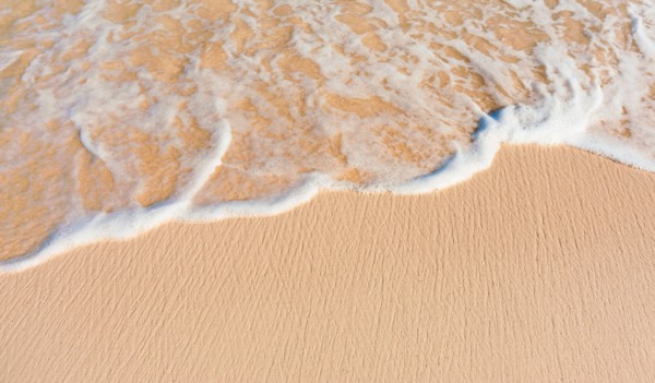 Mexico, Yucatan. Sea waves on beach sand.