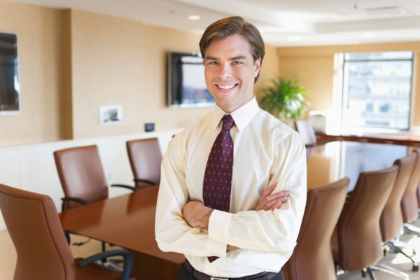 Portrait of businessman in board room.