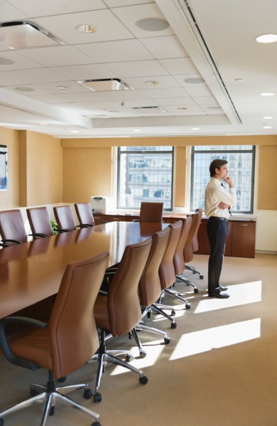 Businessman standing in board room.