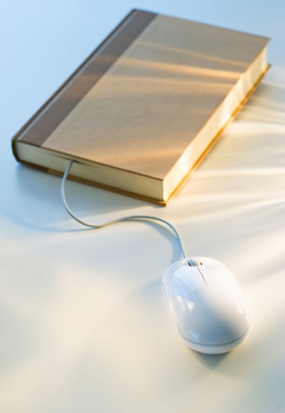 Studio shot of book with computer mouse.