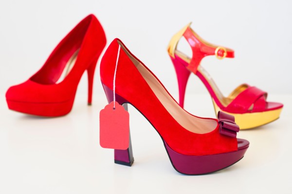 Red high heel shoes with price tag.