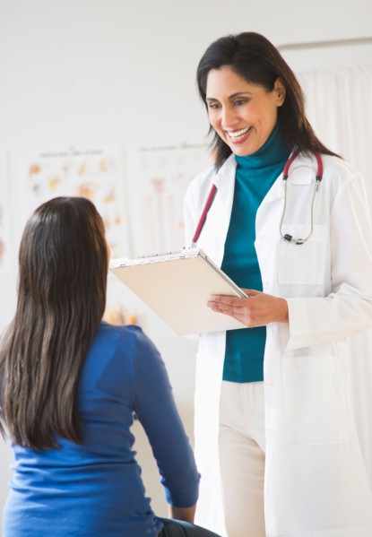 Doctor and patient (12-13) in doctor's office.