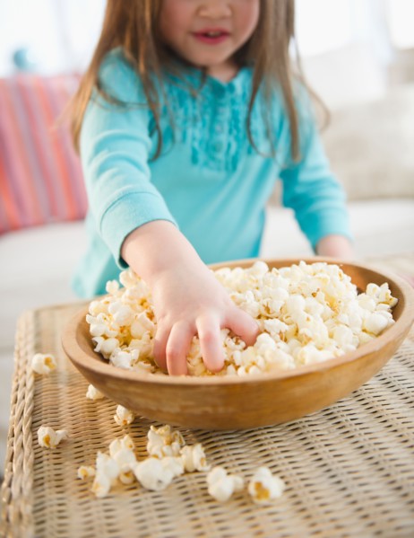 Small girl  (4-5 years) eating popcorn. Photo : Jamie Grill