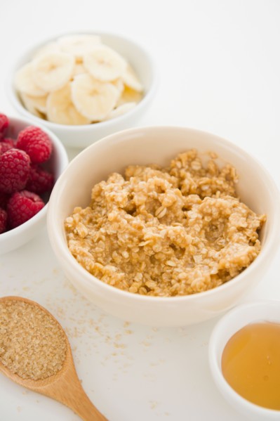 Close up of oats and fruits in bowls, studio shot. Photo : Jamie Grill