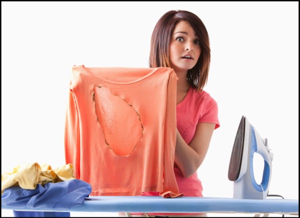 Young woman ironing. Photo : Mike Kemp