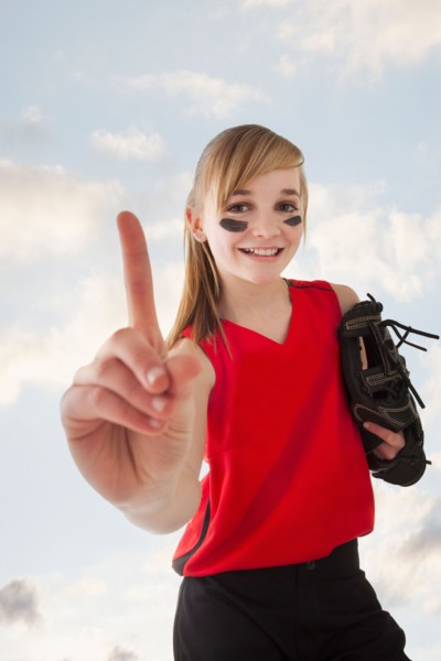 Portrait of girl (12-13) plying softball. Photo : Mike Kemp