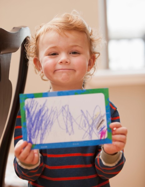 Boy (4-5) showing his drawing. Photo : Mike Kemp