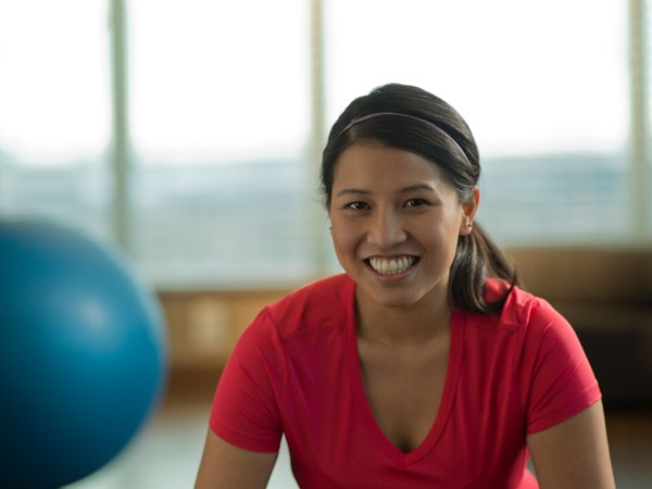 Portrait of Young woman exercising at home. Photo : Dan Bannister