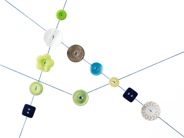 Studio shot of diagram made of thread and buttons. Photo : David Arky