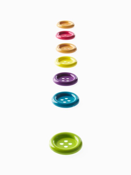 Studio shot of multi colored buttons in a row. Photo : David Arky