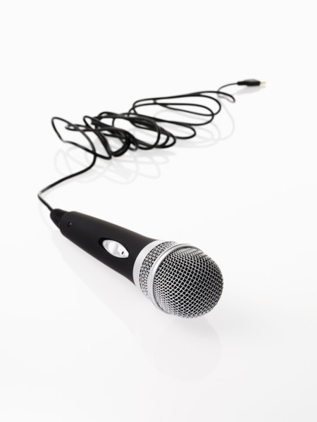 Studio shot of microphone and microphone cable on white background. Photo : David Arky