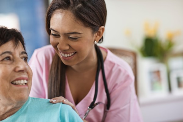 Young female nurse attending patient. Photo : Tim Pannell