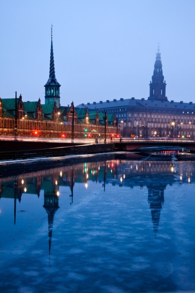 Denmark, Copenhagen. View over canal towards Copenhagen Stock Exchange and Christiansborg Castle.