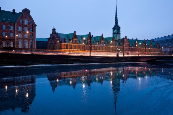 Denmark, Copenhagen. View over canal towards Copenhagen Stock Exchange and Christiansborg Castle.