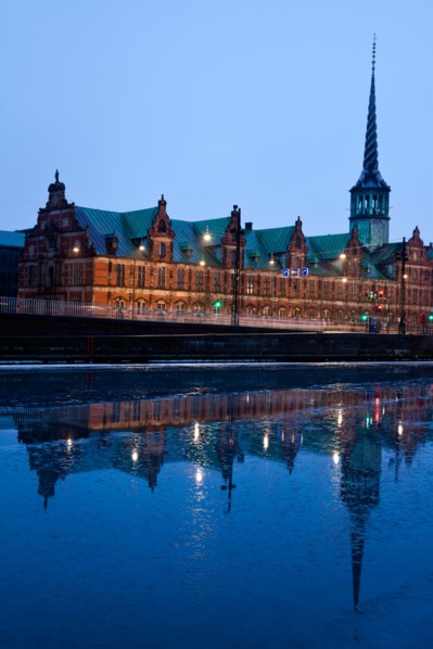 Denmark, Copenhagen. View over canal towards Copenhagen Stock Exchange and Christiansborg Castle.