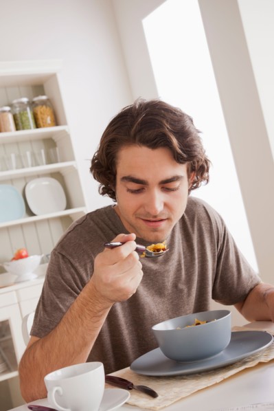 Young man eating. Photo : Rob Lewine