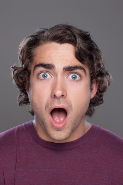 Studio shot of surprised young man. Photo : Rob Lewine