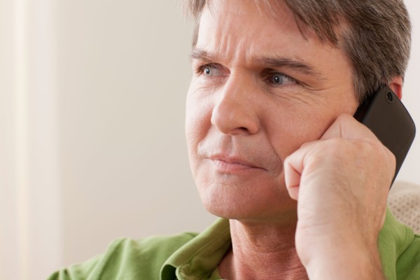 Man talking on phone. Photo : Rob Lewine