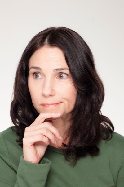 Studio portrait of mature woman with facial expression. Photo : Rob Lewine