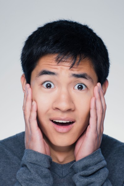Studio portrait of young man with head in hands. Photo : Rob Lewine
