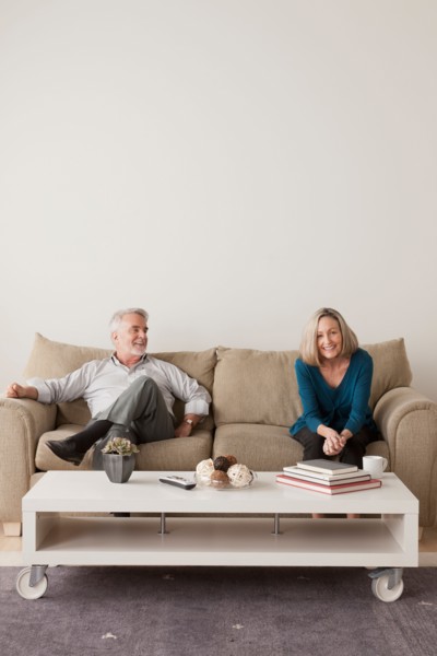 Happy senior couple sitting on sofa. Photo : Rob Lewine