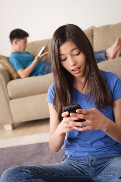 Girl using smartphone. Photo : Rob Lewine