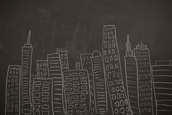 Modern city skyline drawn on blackboard. Photo : Jessica Peterson