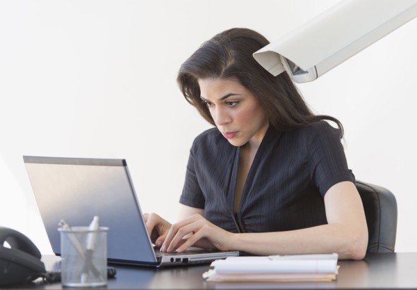 Businesswoman spied on by cctv camera.