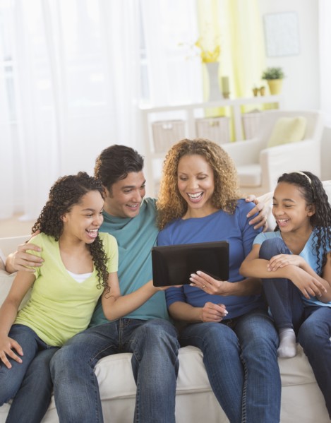 Parents with daughters (10-13) using tablet pc.