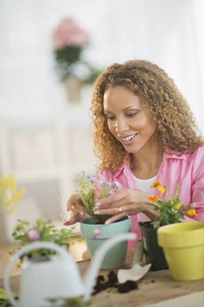 Woman potting flowers.