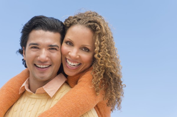 Portrait of couple against blue sky.