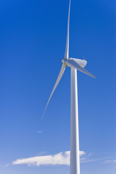 Wind turbine against blue sky.