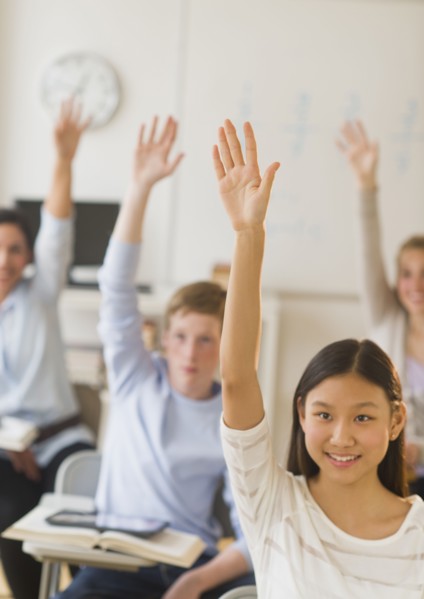 Students (14-19) raising hands.