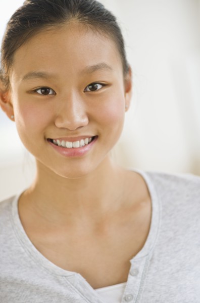Portrait of girl (14-15) smiling.