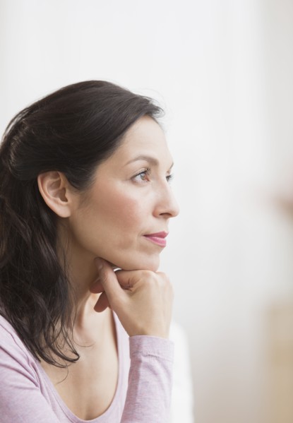 Woman with hand on chin.