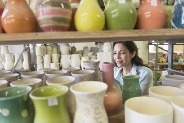 Female artist in pottery in studio.