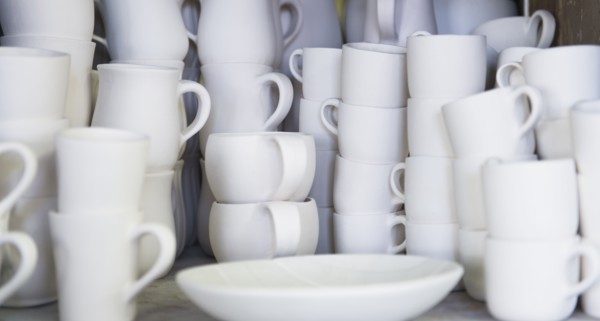 Stacked unfinished white pottery.