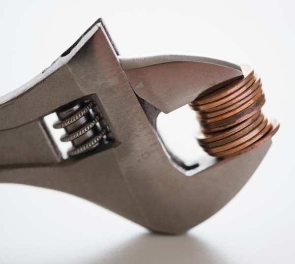 Wrench squeezing coins. 
Photo: Jamie Grill