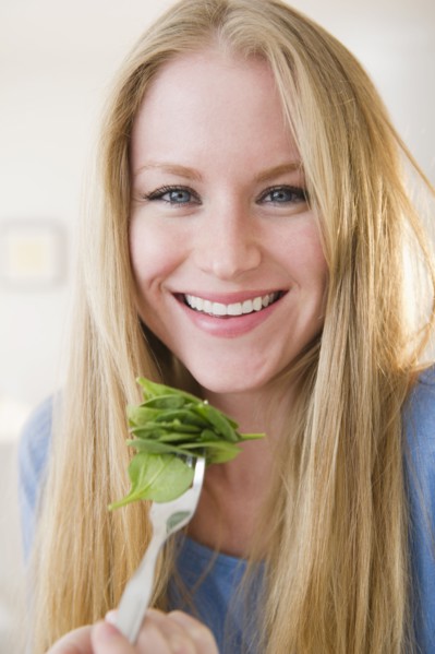 Portrait of woman eating salad. 
Photo: Jamie Grill