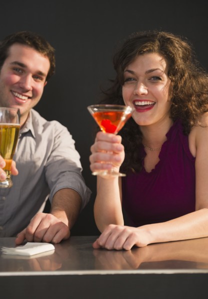 Couple sitting at bar counter and enjoying drinks. 
Photo : Jamie Grill