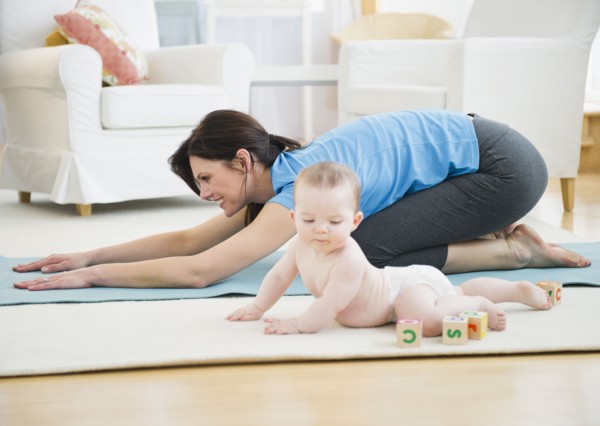 Mother with baby daughter (6-11 months) practicing yoga. 
Photo: Jamie Grill