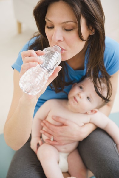 Mother with baby daughter (6-11 months) drinking water. 
Photo: Jamie Grill