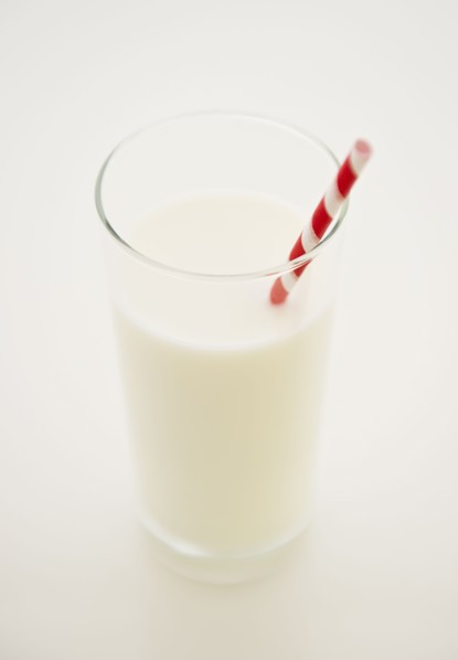 Close up of glass of milk with straw. 
Photo : Jamie Grill