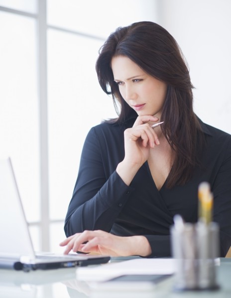 Businesswoman working at desk. 
Photo : Daniel Grill