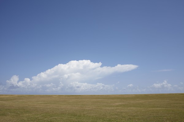 Puerto Rico, Old San Juan, Landscape with field and clouds. 
Photo : Winslow Productions
