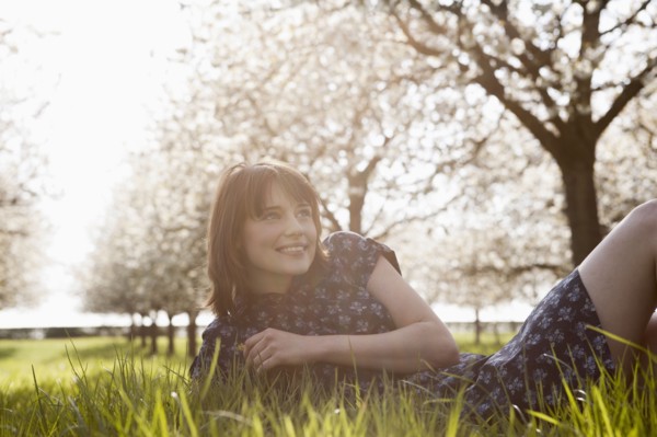 Belgium, Sint-Truiden, Portrait of young woman in spring orchard. 
Photo: Jan Scherders