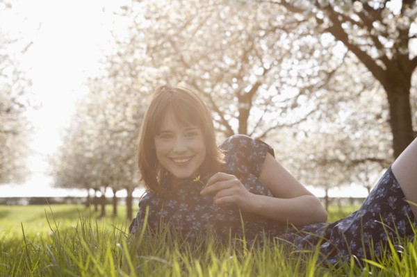 Belgium, Sint-Truiden, Portrait of young woman in spring orchard. 
Photo: Jan Scherders