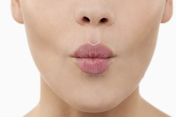 Close-up of female lips blowing kiss. 
Photo : Jan Scherders