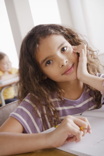 Portrait of schoolgirl holding pencil. 
Photo: Rob Lewine