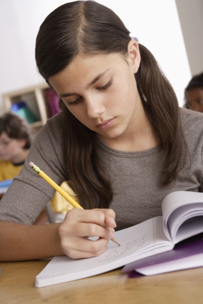 Schoolgirl (12-13) at school. 
Photo : Rob Lewine